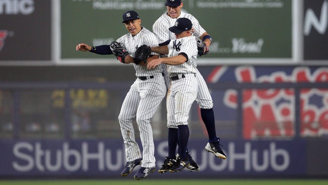 Giancarlo Stanton, Aaron Judge and Brett Gardner celebrate after a win.