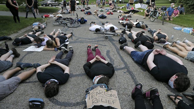 Ddemonstrators lay on the road in front of Mayor Andrew J. Ginther's house for eight minutes and 46 seconds Wednesday evening, the amount of time that George Floyd was pinned to the ground by a Minneapolis police officer before his death.