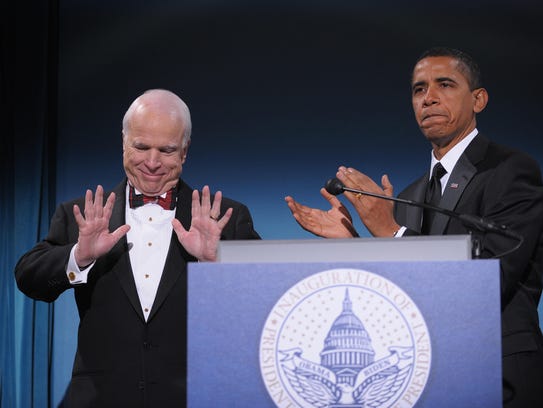 Then-President-elect Barack Obama applauds Arizona