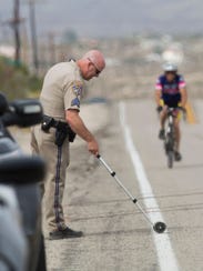 A California Highway Patrol officer investigates the