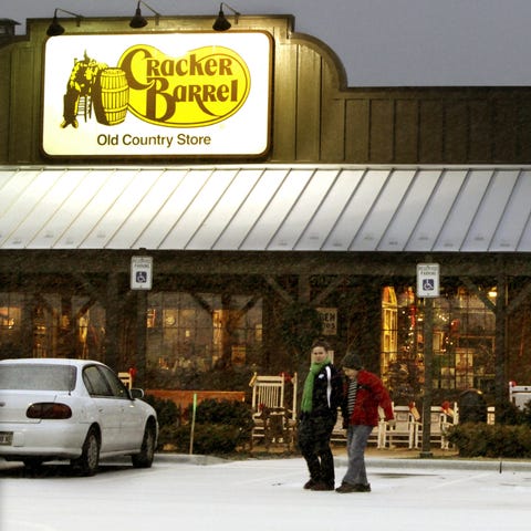 Patrons leave a Cracker Barrel restaurant and stor