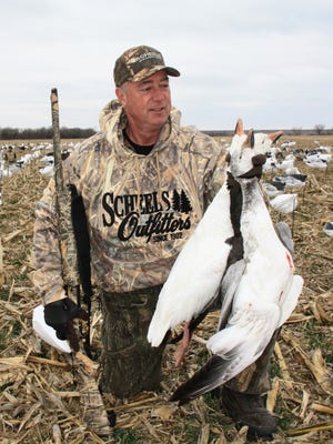 Local hunter Brian Corrigan holds a few snow geese taken during a Kansas hunting trip.