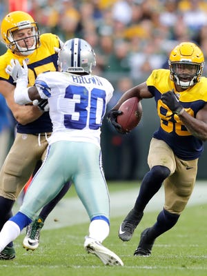 Green Bay Packers receiver Ty Montgomery runs as Jordy Nelson blocks Dallas Cowboys cornerback Anthony Brown following a reception in the second half at Lambeau Field.