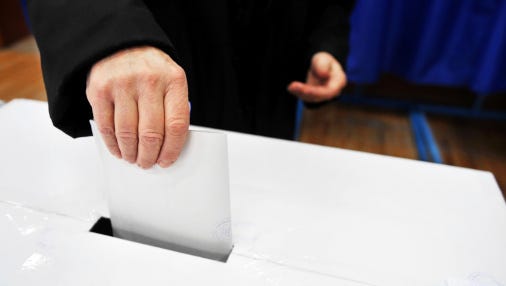 A stock image of a person voting.