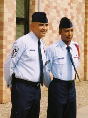 Then, Amn 1st Class, now, 1st Lt. Kenneth Ellison stands next to his uncle, Chief Master Rodney Ellison during his technical school graduation in 2004. Lieutenant Ellison graduated from Commissioned Officer Training June 22 at Maxwell Air Force Base, Ala and is continuing his family's tradition of service, which dates back to September 1947, when his grandfather started Air Force Basic Training.