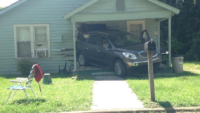 A woman backed her vehicle through the front of a Peabody Avenue home.