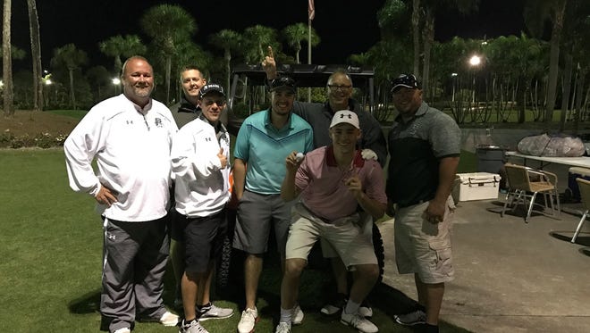John Plocharczyk Jr. and others celebrate after he made a hole-in-one on No. 6 in the Palmetto Ridge High School softball team's fundraising tournament at The Links of Naples on March 4, 2017.