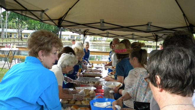 Sunrise Rotarians serve the residents and guests.