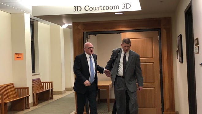 Loveland Police Sgt. Justin Chase leaves the courtroom with defense attorney Patrick Welsh on Friday after being found not guilty on all charges related to his excessive force case