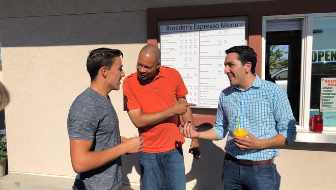 State Sen. Aaron Ford, D-Las Vegas, and Assemblyman Nelson Araujo, D-Las Vegas, chat with Tyler Dennis during a campaign stop at Broeder's Espresso in Fernley on June 1, 2018.