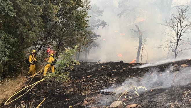 A 3-acre fire burns in the canyon off North Market Street and Lake Boulevard on Saturday in north Redding.