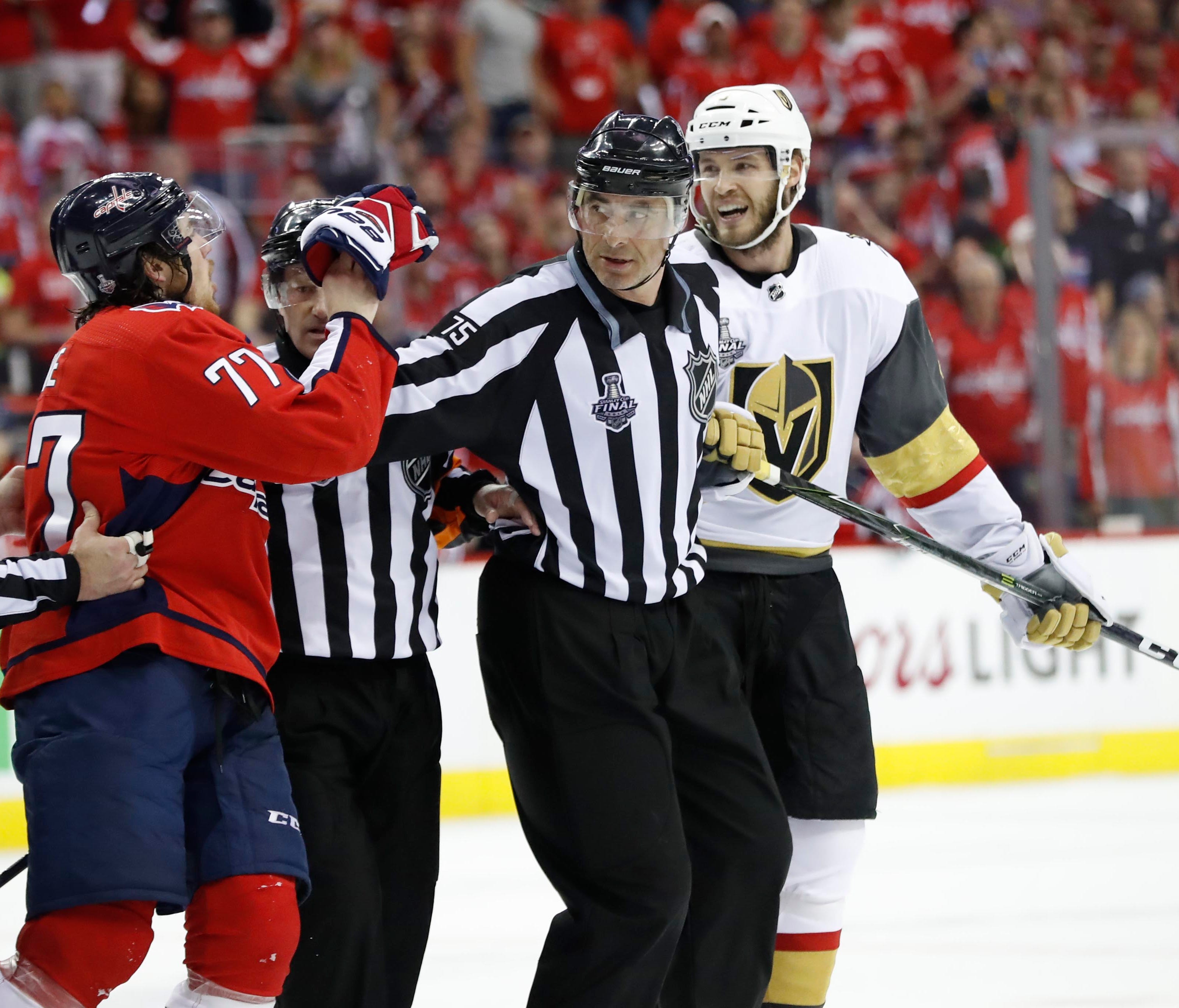 NHL linesman Derek Arnell separates Washington Capitals right wing T.J. Oshie and Vegas Golden Knights defenseman Brayden McNabb in the third period.