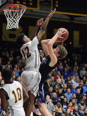 Brookfield Central forward Chris Post attempts a shot  against Milwaukee Vincent guard Alfonzo Fields during the Division 1 boys basketball sectional final Saturday at West Allis Central High School.