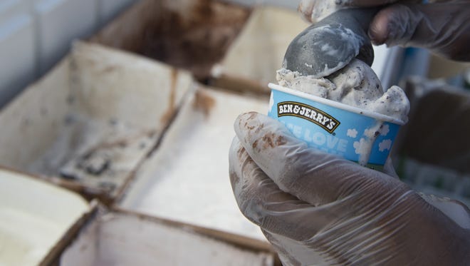 An employee of Ben & Jerry's scoops ice cream into a cone outside Union Station in Washington on June 18, 2013. The St. Albans, Vermont, facility that produces two-thirds of the company's ice cream is planning an expansion.
