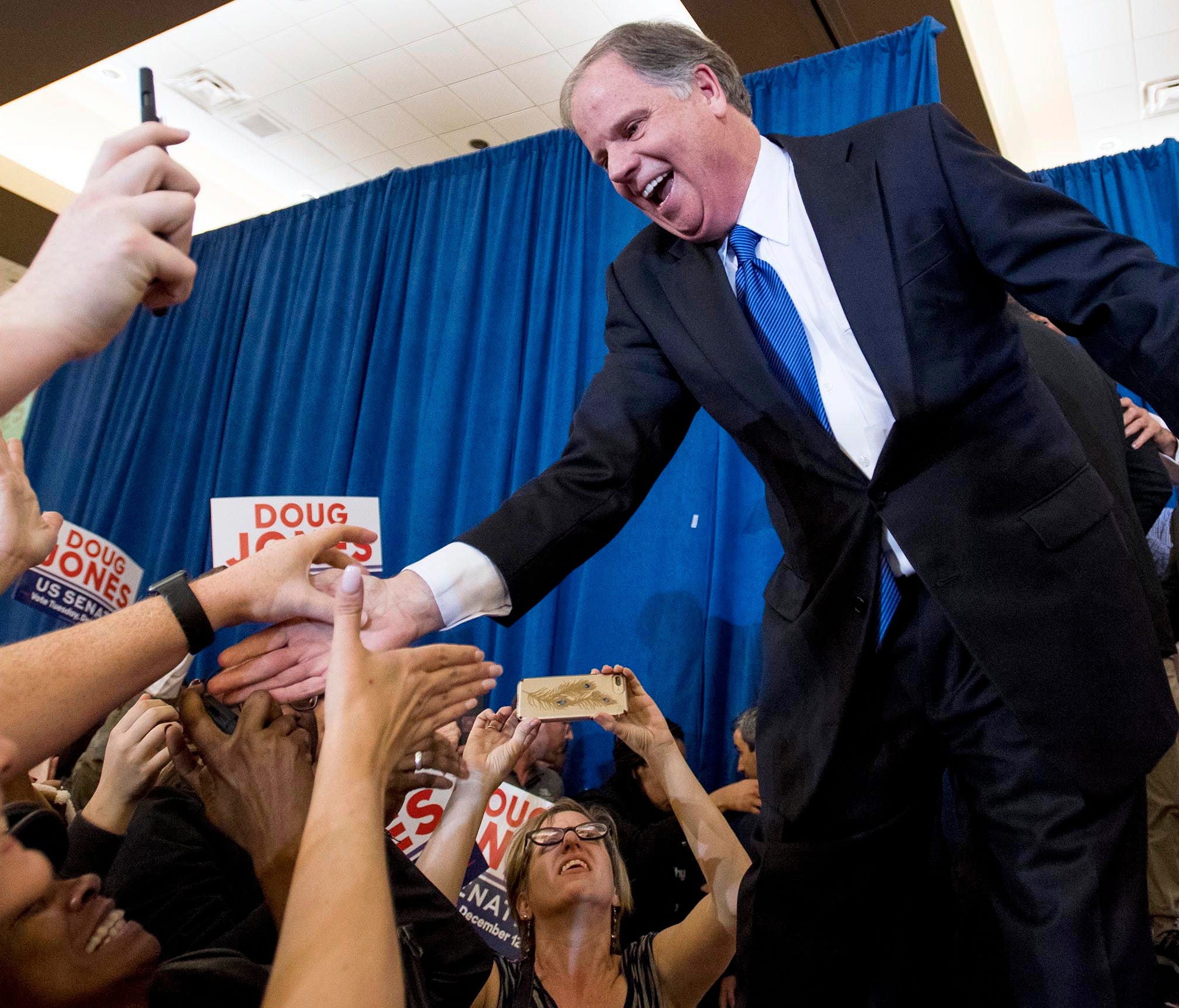 Doug Jones greets supporters as he claims victory at his watch party in Birmingham.