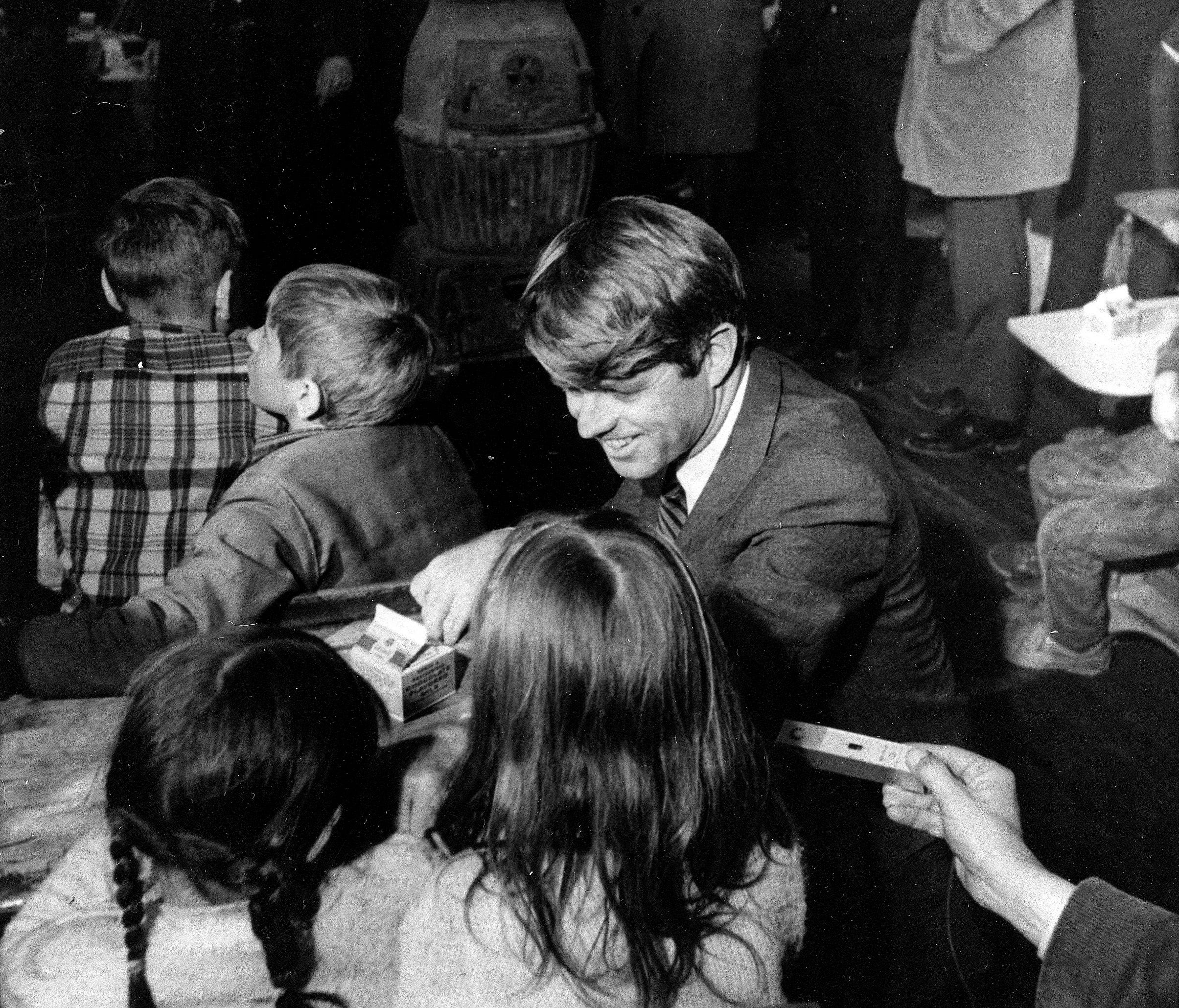 Sen. Robert F. Kennedy, D-N.Y., chats with two girls at Millers Branch School, a one-room school in Breathitt County, Ky.