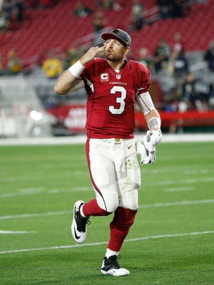 Arizona Cardinals QB Carson Palmer blows a kiss toward the stands after defeating the Green Bay Packers 38-8 in an NFL game on December 27, 2015, in Glendale.
