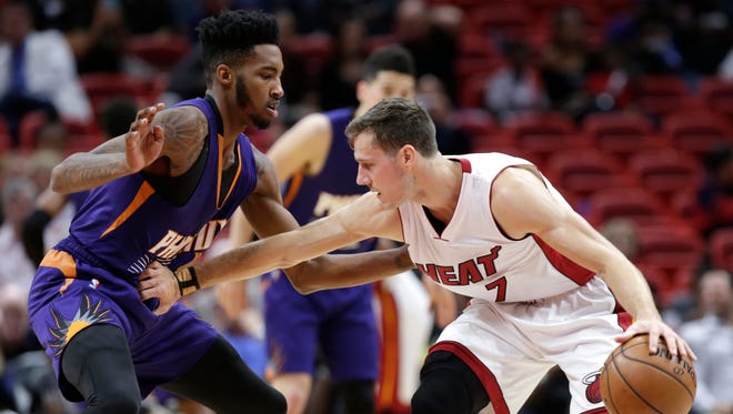 Miami Heat's Goran Dragic (7) drives to the basket as Phoenix Suns' Derrick Jones Jr. defends during the first half of an NBA basketball game, Tuesday, March 21, 2017, in Miami.