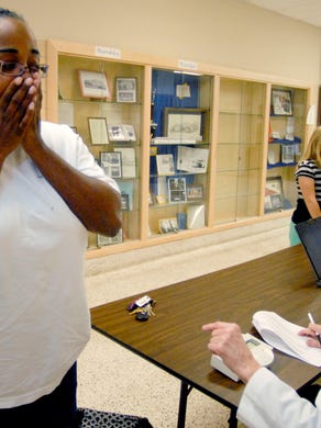 Donya Walker, 26, left, of Knoxville, gasps in excitement as Dogwood Elementary school nurse Elaine Adams, informs Walker that she has lost seven pounds on Tuesday, March 24, 2009 at the Sarah Simpson Center in Knoxville, Tenn. Walker, an interpreter for West High School, was a part of the eWellness program, which more than 300 Knox County Schools' employees participated in.