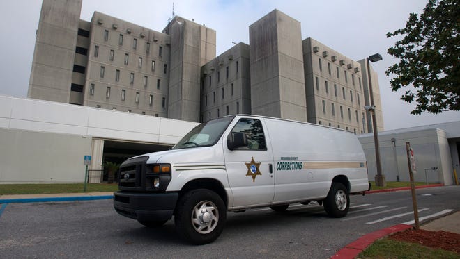 Escambia County Corrections transport vans leave the jail en route to the M.C. Blanchard Judicial building on April 20, 2017.