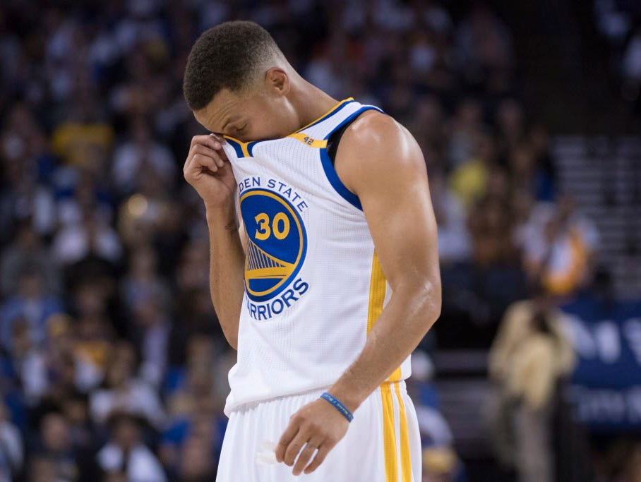 Warriors guard Stephen Curry (30) reacts during the third quarter against the Spurs.