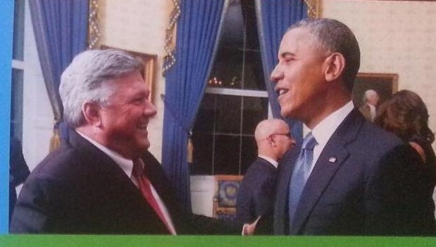 A recent campaign door-hanger of mayoral candidate Bill Freeman features an image with him and President Barack Obama.