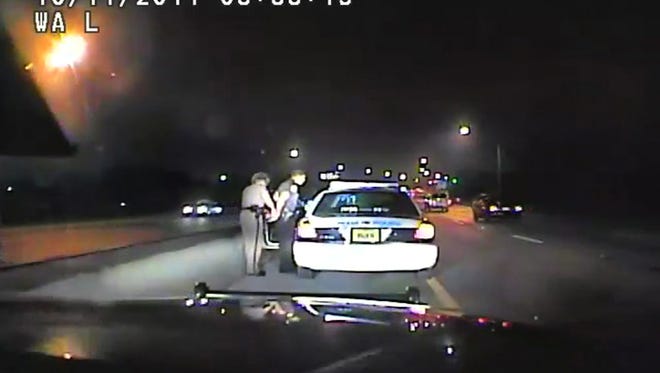 In this image made from an Oct. 11, 2011 video made available by the Florida Department of Highway Safety and Motor Vehicles, Florida Highway Patrol Officer Donna Watts arrests Miami Police Department Officer Fausto Lopez who was traveling at 120 miles per hour to an off-duty job, in Hollywood, Fla. After the incident, Watts says that she was harassed with prank calls, threatening posts on law enforcement message boards and unfamiliar cars that idled near her home. In lawsuits, she accused dozens of officers of obtaining information about her in the state’s driver database. (Florida Department of Highway Safety and Motor Vehicles via AP)