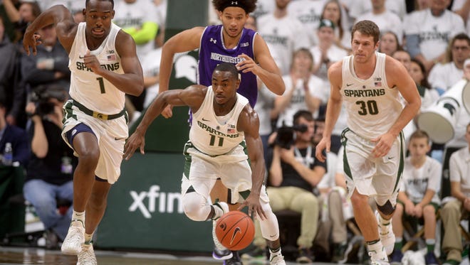Junior guard Tum Tum Nairn Jr. runs the ball down the court during the game against Northwestern on Friday, Dec. 30, 2016 at Breslin Center.