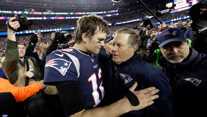 In this Jan. 21, 2018, file photo, New England Patriots quarterback Tom Brady, left, hugs coach Bill Belichick after the AFC championship NFL football game against the Jacksonville Jaguars in Foxborough, Mass. Opponents tend to freak out against Brady and Belichick just when they’re about to conquer the New England Patriots’ dynastic duo. The Philadelphia Eagles swear they won’t fall into that trap if they have the chance in Super Bowl 52.