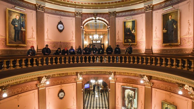 Armed ralliers protest in the rotunda inside the Michigan Capitol on Thursday. April 30, 2020.