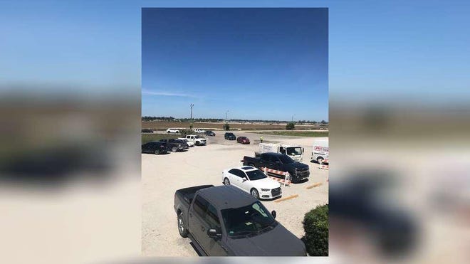 Cars line up at J&J Family of Farms in Westlake on Wednesday to buy $10 boxes of produce. The farm at 4003 Seminole Pratt Whitney Road has set up a drive-through that will be open 9 a.m. to 4 p.m. Monday-Saturday.
