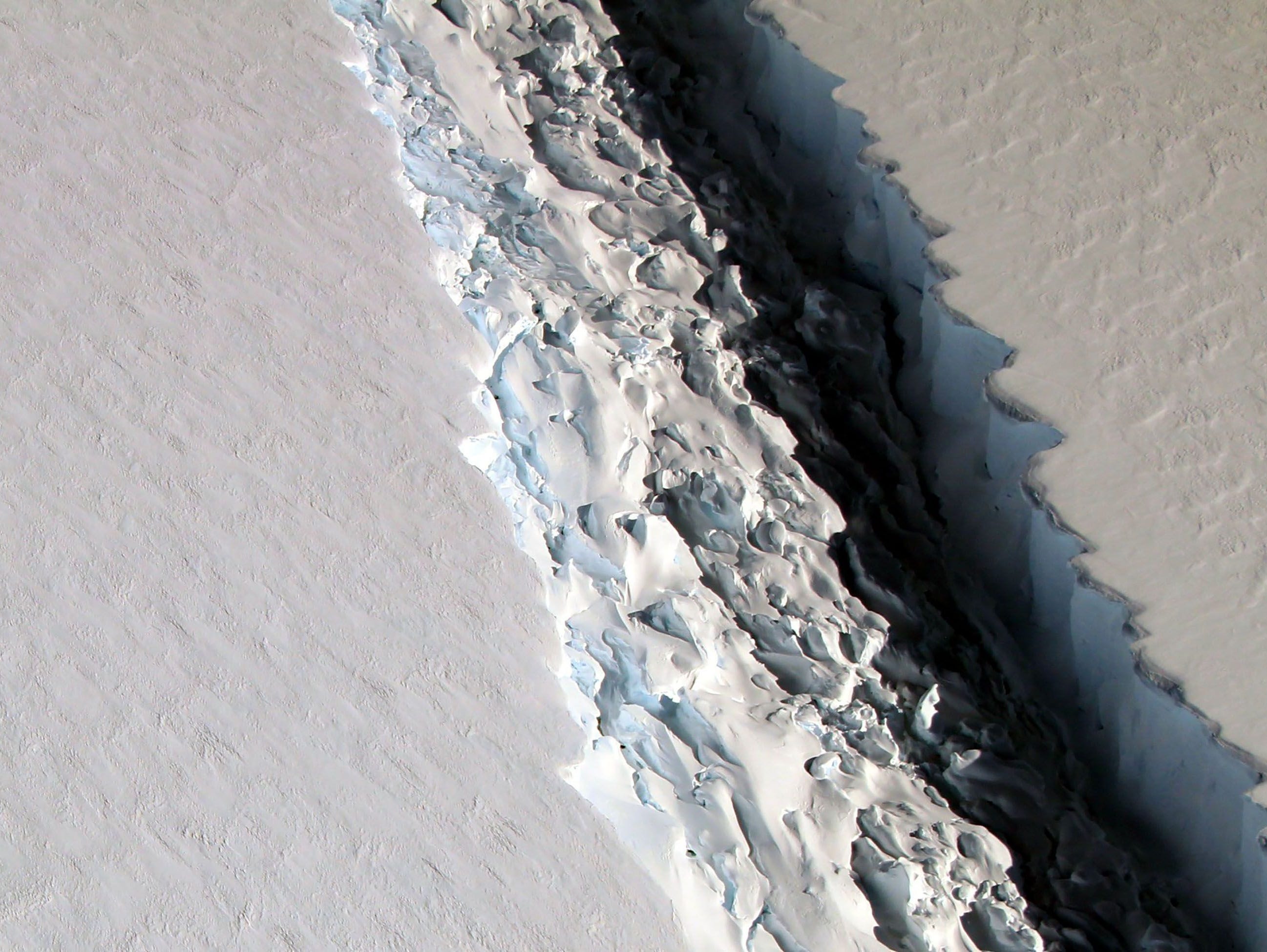 This photo released on Dec. 1, 2016, by NASA shows what scientists photographed in a view of a massive rift in the Antarctic Peninsula's Larsen C ice shelf on Nov. 10, 2016.