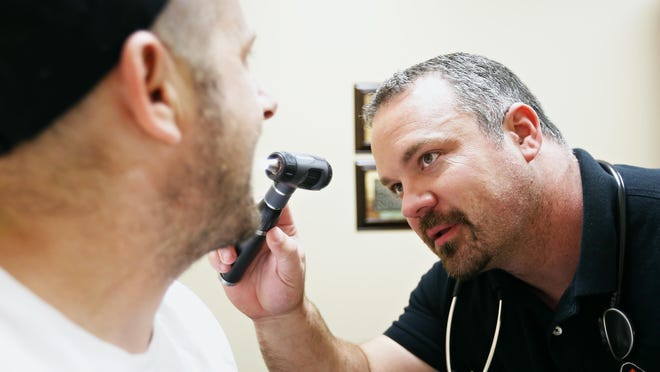 Direct primary care physician Billy Holt examines one of his regular patients, Brian Howe, at Holt's VIP Medical Services practice in Ozark, Mo. on Oct. 6, 2015.
