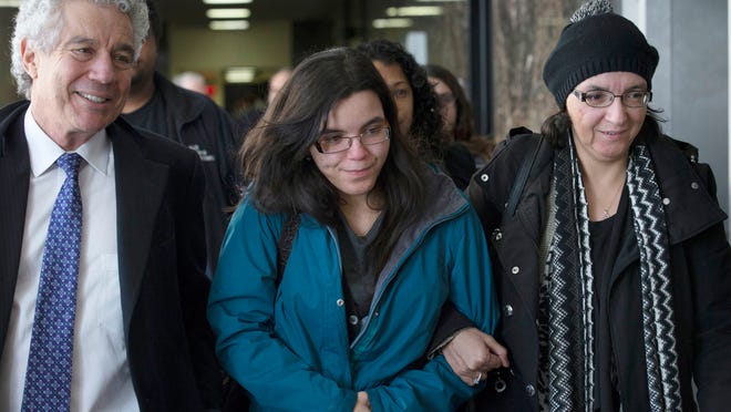 Becky Hernandez, daughter of Pedro Hernandez, center, leaves during a break in proceedings of the Etan Patz murder trial where her father is accused, alongside her mother Rosemary Hernandez, right, and attorney Harvey Fishbein, Monday, March 9, 2015, in New York. Becky Hernandez, 25, testified Monday about her strict upbringing and the effect her father's arrest had on her. (AP Photo/John Minchillo)