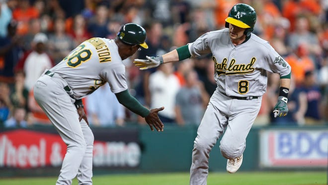 Jun 4, 2016; Houston, TX, USA; Oakland Athletics second baseman Jed Lowrie (8) is congratulated by third base coach Ron Washington (38) after hitting a home run during the ninth inning against the Houston Astros at Minute Maid Park. Mandatory Credit: Troy Taormina-USA TODAY Sports
