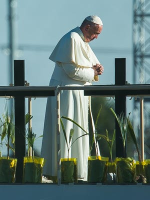 Pope Francis prays at the top of a ramp Wednesday in Juárez before blessing a crowd watching from a levee in El Paso.