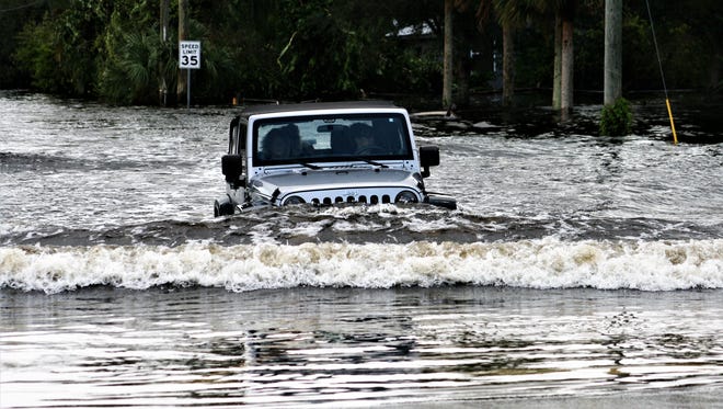 The Orange River flooded Cemetery Road, but many vehicles braved the waters by midday Monday. 