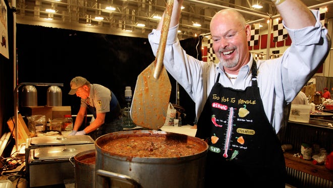 Gary Yost, with Import Specialist and Metropolitan Grill, stirs chili with a paddle during the 29th annual Sertoma Chili Cook-Off at the Springfield Exposition Center Saturday, February 13, 2010.