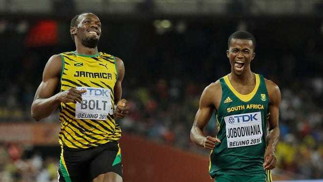 Jamaica's Usain Bolt, left, and South Africa's Anaso Jobodwana laugh after competing in a men’s 200m semifinal at the World Athletics Championships at the Bird's Nest stadium in Beijing, Wednesday, Aug. 26, 2015.