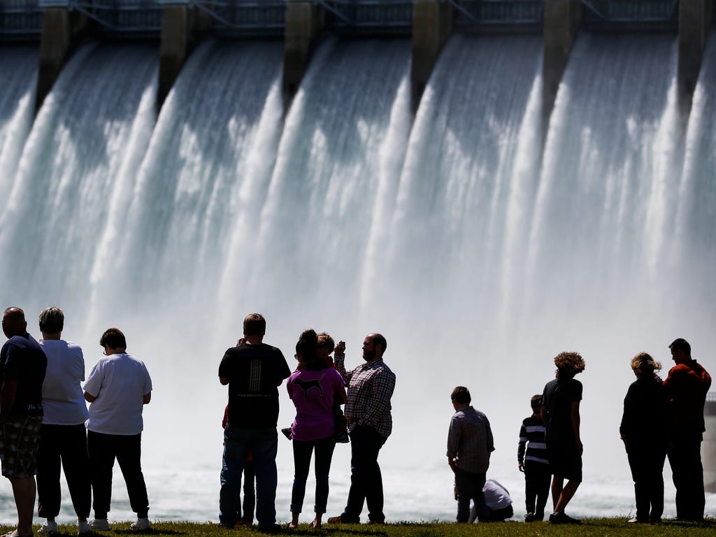 People watch as as Table Rock Dam releases 50,000 CFS of water into Lake Taneycomo in Missouri. Lake Taneycomo is expected to flood as water is released into it from Table Rock Lake.