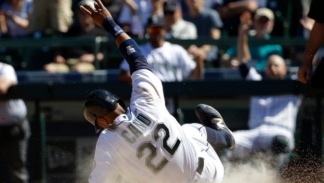 Seattle Mariners' Robinson Cano scores on sacrifice fly hit by Nelson Cruz in the seventh inning of a baseball game against the Tampa Bay Rays, Wednesday, May 11, 2016, in Seattle. (AP Photo/Ted S. Warren)