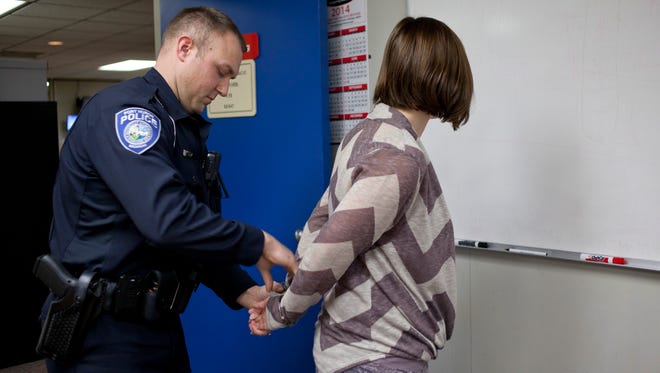 The Port Huron Police Department is taking applications for its Citizen's Police Academy. Officer Dan Stocker demonstrates an arrest with Jenny Leach at the police station during a previous academy.