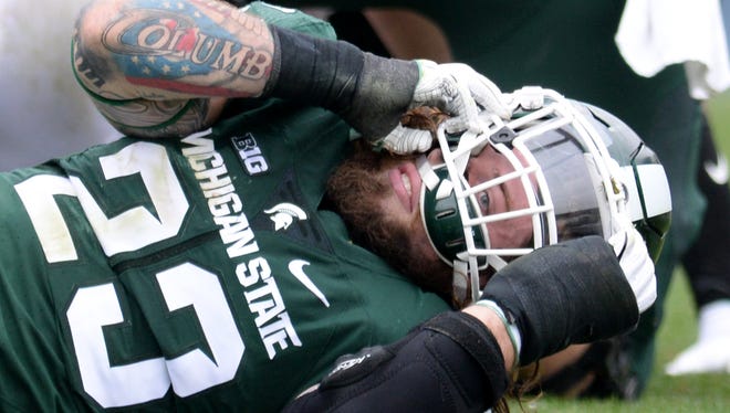 Michigan State junior linebacker Chris Frey lays on the ground after a collision during the game against Michigan on Oct. 29, 2016 at Spartan Stadium in East Lansing.