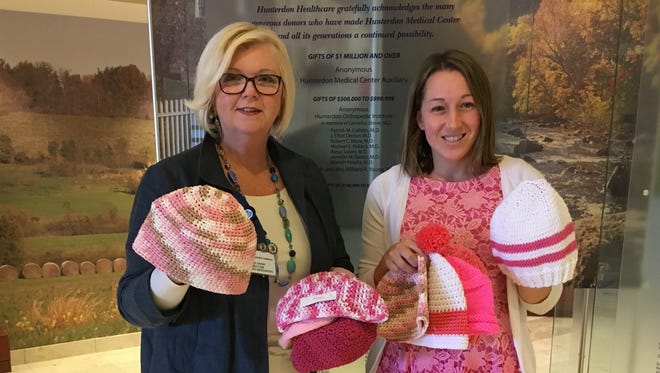 Lynne Danik (left), head of the volunteer department at Hunterdon Medical Center, and Jen Exley of the hospital's marketing department, hold some of the 133 hats you made for them that I delivered Oct. 3.