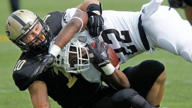 Purdue's Sean Robinson, left, tackles Western Michigan's Dareyon Chance during an NCAA college football game Saturday, Aug. 30, 2014, in West Lafayette, Ind. Purdue won 43-34. (AP Photo/Journal & Courier, John Terhune) NO SALES