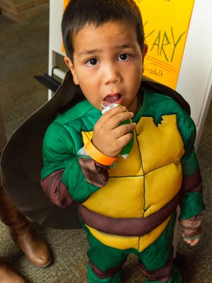 Dressed as a Ninja Turtle, Phoenix Lopez, 4, attends the Hillrise Elementary School Fall Festival on Friday, October 28, 2016, with his brother, who attends the school, Prince Lopez, 8.