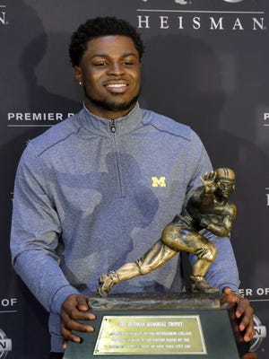 Heisman Trophy finalist Jabrill Peppers poses with the award in New York, Friday, Dec. 9, 2016.