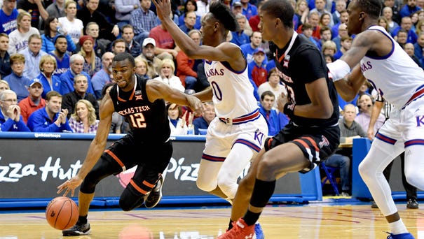 Texas Tech guard Keenan Evans dribbles the ball...