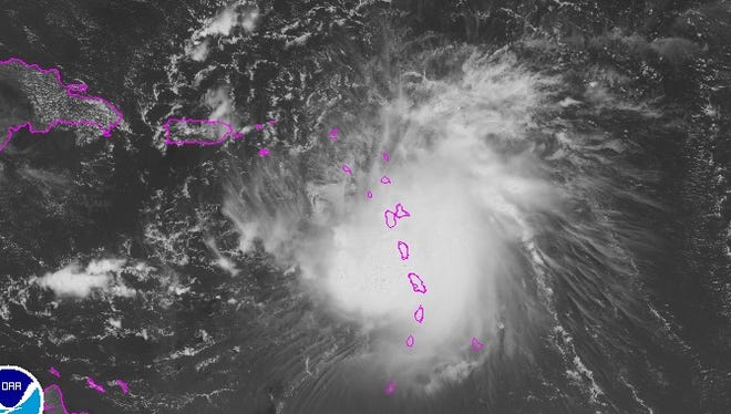 A satellite image shows Tropical Storm Erika swirling over the Leeward Islands Thursday morning.