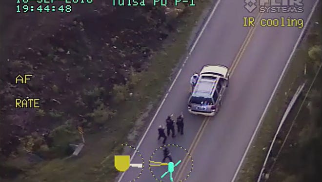 In this image made from a Friday, Sept. 16, 2016 police video, Terence Crutcher, top, is pursued by police officers as he walk to an SUV in Tulsa, Okla. Crutcher was taken to the hospital where he was pronounced dead after he was shot by the officer around 8 p.m., Friday, police said. Crutcher had no weapon on him or in his SUV, Tulsa Police Chief Chuck Jordan said Monday, Sept. 19, 2016.